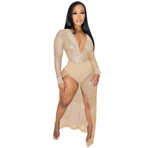 Detail of deep V-neck rhinestone dress with long sleeves and shimmering pearl beadwork