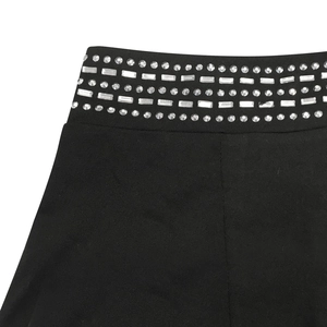 Macro shot of rhinestone belt detailing on black high-stretch knitted two-piece set