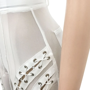 Detail of white mesh patchwork trousers with side lace-up design and metal eyelets