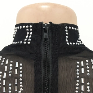 Close-up of black mesh top with silver rhinestones and high collar back zipper detail