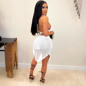 Detailed view of white sequined fringe mini dress with backless halter design