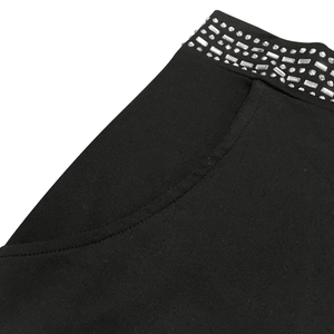 Detail of black shorts with shiny silver rhinestone trim and a side pocket detail