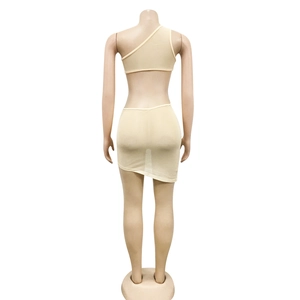 Detail of the open back design on a beige rhinestone bodycon dress with irregular hem