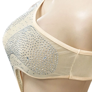 Close-up detail of sheer mesh bodysuit with shimmering silver rhinestones and marquise gems