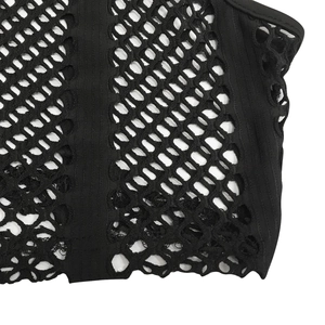 Detail of black rhinestone mesh meshwork showing the elastic diamond weave and edge binding
