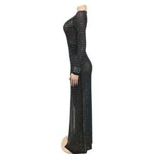 Detailed close-up of a black mesh maxi dress with sparkling rhinestones and slim fit design