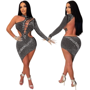 Detailed view of backless irregular dress with sparkling rhinestones and cut-outs