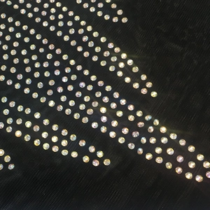 Détail du tissu en maille noire orné de strass AB scintillants pour cette robe de soirée