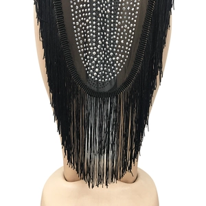 Close-up of black mesh evening dress featuring silver rhinestones and layered fringe detail