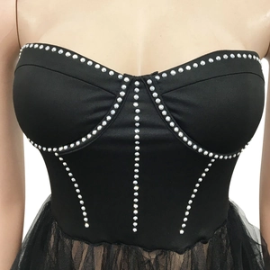 Detail of sweetheart neckline with silver rhinestones on a black mesh dress