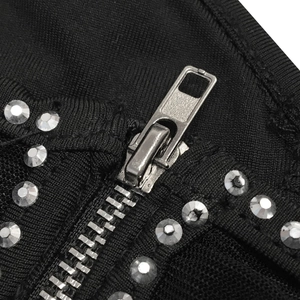 Close-up of black fabric with silver metal zipper and decorative rhinestone rows