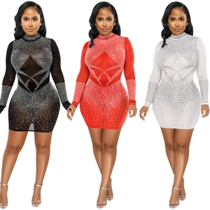 Detailed close-up of rhinestones and sheer mesh fabric on sexy bodycon mini dress