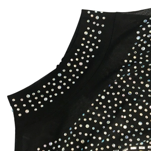 Macro detail of black mesh dress featuring sparkling rhinestones on sheer fabric