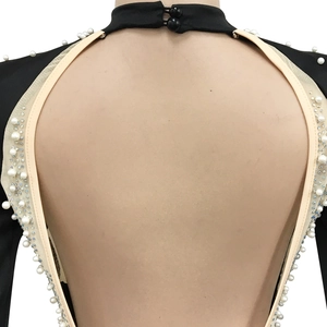 Detail of backless mesh dress with white pearls, rhinestones, and stand collar