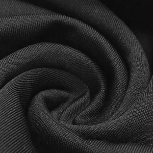 Macro shot of premium black knitted fabric texture with soft spiral fold details