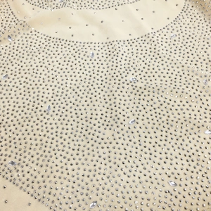 Close-up of champagne mesh fabric with silver rhinestones and marquise crystals