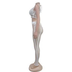 Detail of white mesh two-piece set featuring sequin accents and sheer high-waist pants
