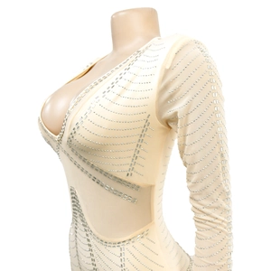 Detail of sheer long sleeve dress featuring silver rhinestone geometric patterns and V-neckline
