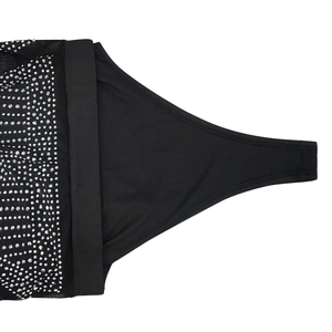 Detail of black sheer mesh dress with silver rhinestones and premium knit texture