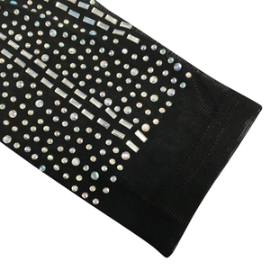 Detail of mesh fabric with sparkling rhinestones and elastic cuff on long sleeve dress