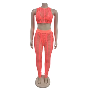 Detailed view of neon orange rhinestone mesh tank top and matching leggings on mannequin