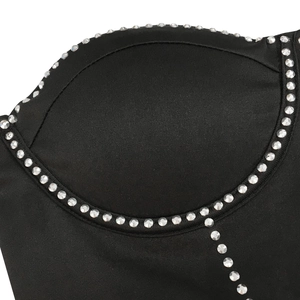 Close-up of black bustier top with silver rhinestone embellishment along the cups
