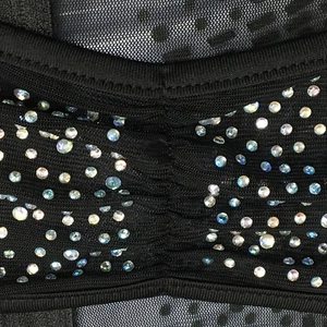 Close-up of black sheer mesh dress featuring sparkling AB rhinestones and pleated fabric detail