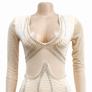 Close-up detail of sheer mesh bodysuit featuring silver rhinestones and deep U-neck design