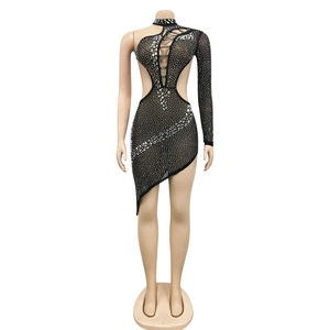 Detailed view of black asymmetrical party dress with silver rhinestones and cut-outs