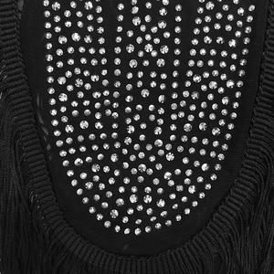 Detailed macro view of black mesh fabric with sparkling silver rhinestones and fringe trim