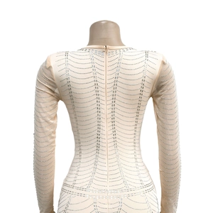 Detail of the back hidden zipper and sparkling rhinestones on mesh dress