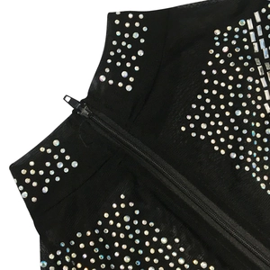 Detail of black mesh dress with shimmering rhinestones and smooth nylon zipper