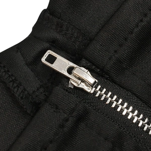 Detail view of a durable silver metal zipper on premium black mesh dress fabric