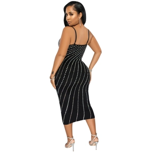 Detailed view of the slim fit black midi dress featuring vertical colorful rhinestone patterns