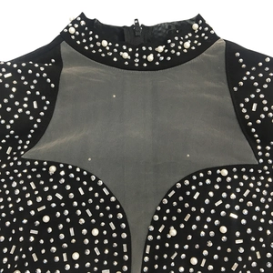 Détail de robe en mesh transparent avec strass, perles et fermeture éclair au col