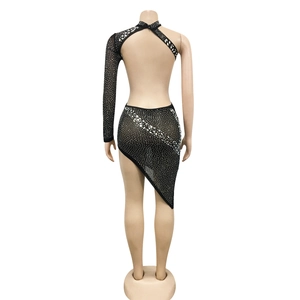 Detailed back view of a black mesh dress with rhinestones and asymmetric cutout design
