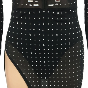 Close-up of black mesh bodysuit with silver studs and sparkling crystal embellishments