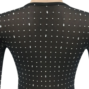 Detail of black mesh top featuring sparkling silver rhinestones and premium fabric texture