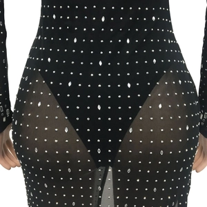 Detail of silver rhinestones on black mesh and long sleeve v-neck split dress