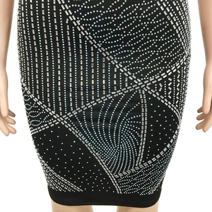Gros plan des strass argentés géométriques et motifs spirales sur une robe moulante