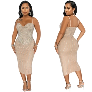 Close-up of nude bodycon midi dress with shimmering silver rhinestones and sweetheart neckline