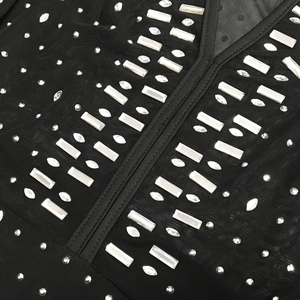 Macro shot of black mesh fabric with sparkling rhinestones in a geometric pattern