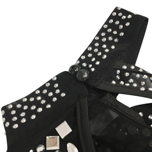 Close-up of black mesh fabric with rhinestones and mirror sequins on a party dress