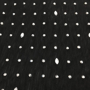 Detailed macro view of black mesh fabric with sparkling silver rhinestones