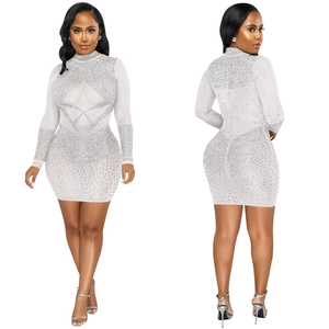 Detail of white rhinestones mesh dress showing sheer fabric and sparkling geometric patterns