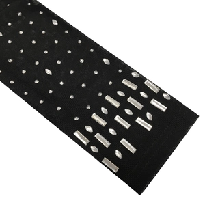 Detail of black mesh fabric with sparkling rhinestones for evening dress embellishment