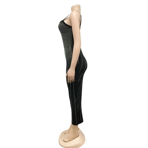 Detailed view of women's black bodycon dress with sparkling silver rhinestone stripes