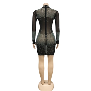 Detail view of the back of a black mesh dress with rhinestones and an invisible zipper