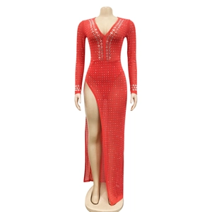 Detail of red long sleeve evening gown featuring deep V-neck and sparkling rhinestones