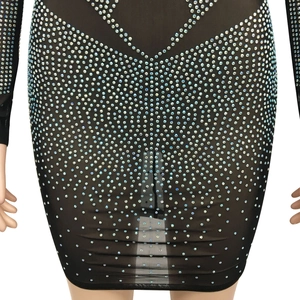 Close-up of black mesh dress featuring dense iridescent rhinestones in a geometric pattern